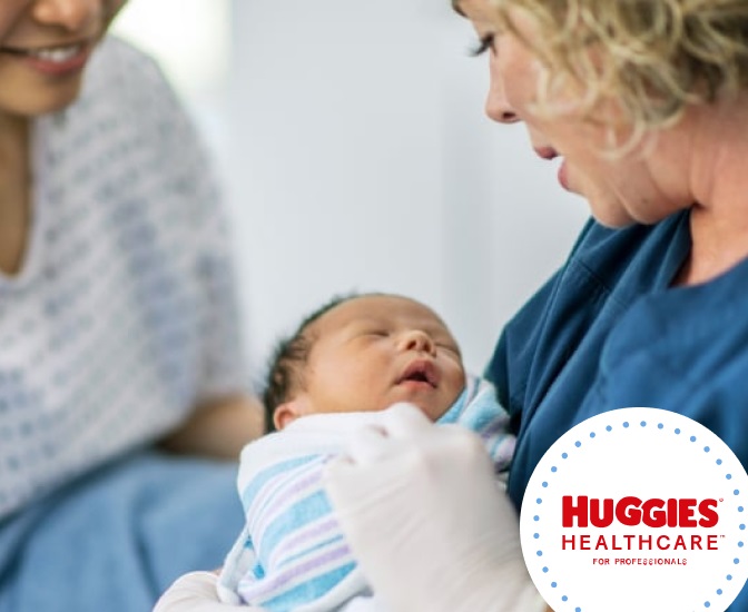 A Healthcare worker holding a newborn baby in her arms