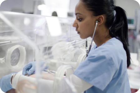 A healthcare nurse looking after a baby in NICU