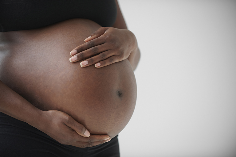 Woman holding her pregnant belly