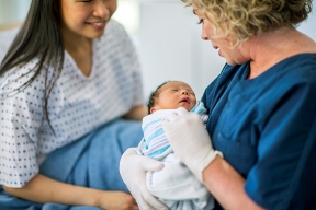 Nurse holding baby with mom1