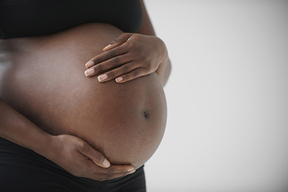 Woman holding her pregnant belly